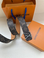 Louis Vuitton monogram belt set with dark patterned strap and gold-tone buckle, tan reverse