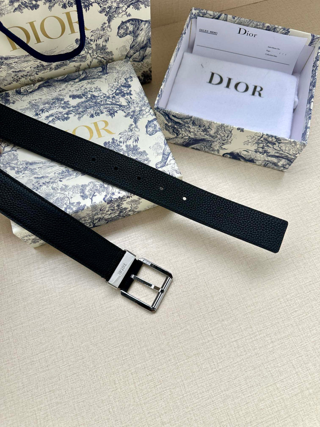 Dark navy leather belt with silver buckle and stitched edge