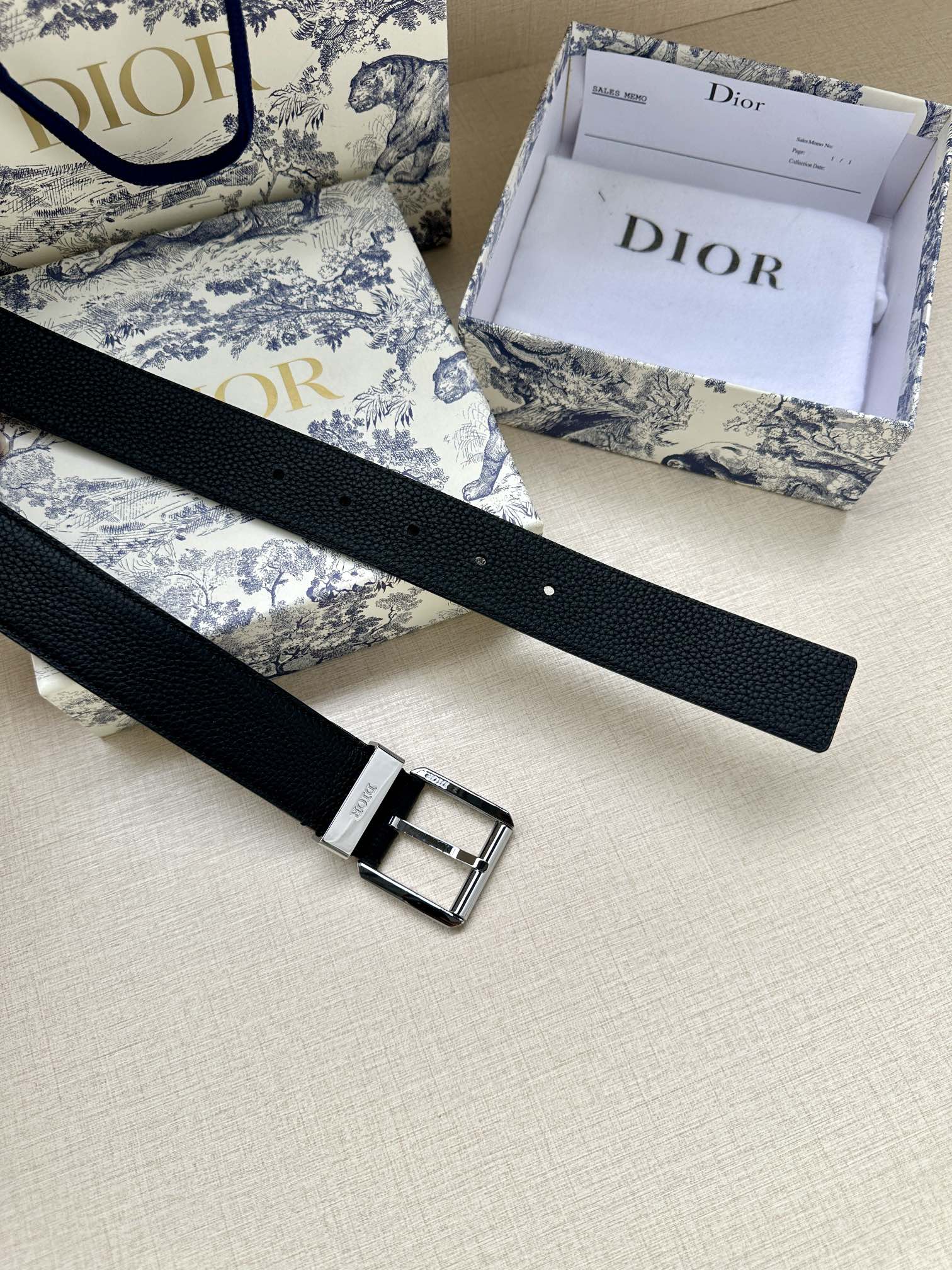 Dark navy leather belt with silver buckle and stitched edge