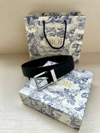 Dark navy leather belt with silver buckle and embossed logo on strap