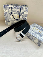 Dark navy leather belt with silver square buckle and punched adjustment holes