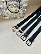 Dark navy leather belt set with gold and silver buckles and adjustment holes