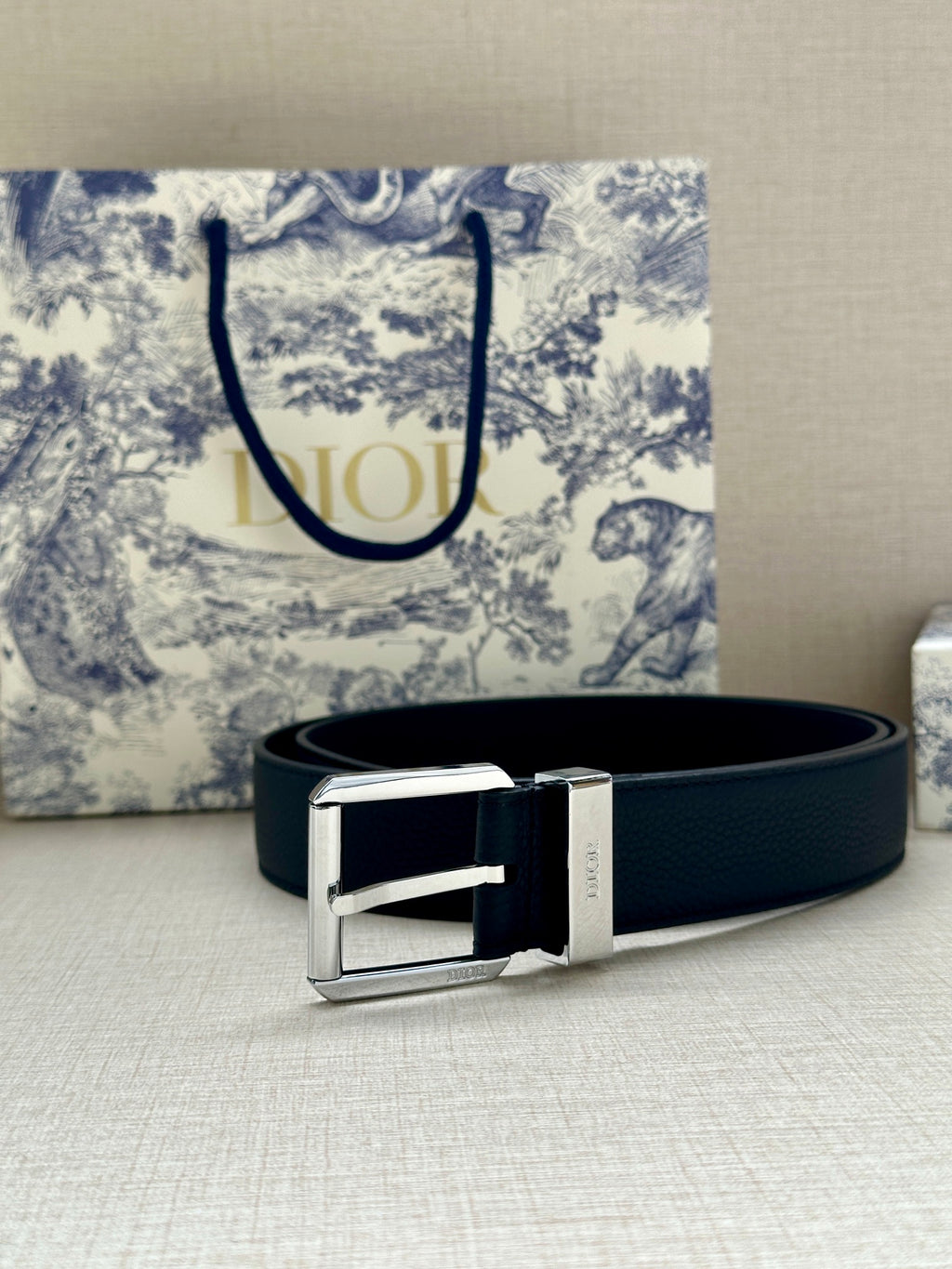 Dark navy leather belt with silver buckle and rectangular frame detail