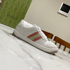 White Gucci unisex sneakers, side view with red green stripe and lace-up design