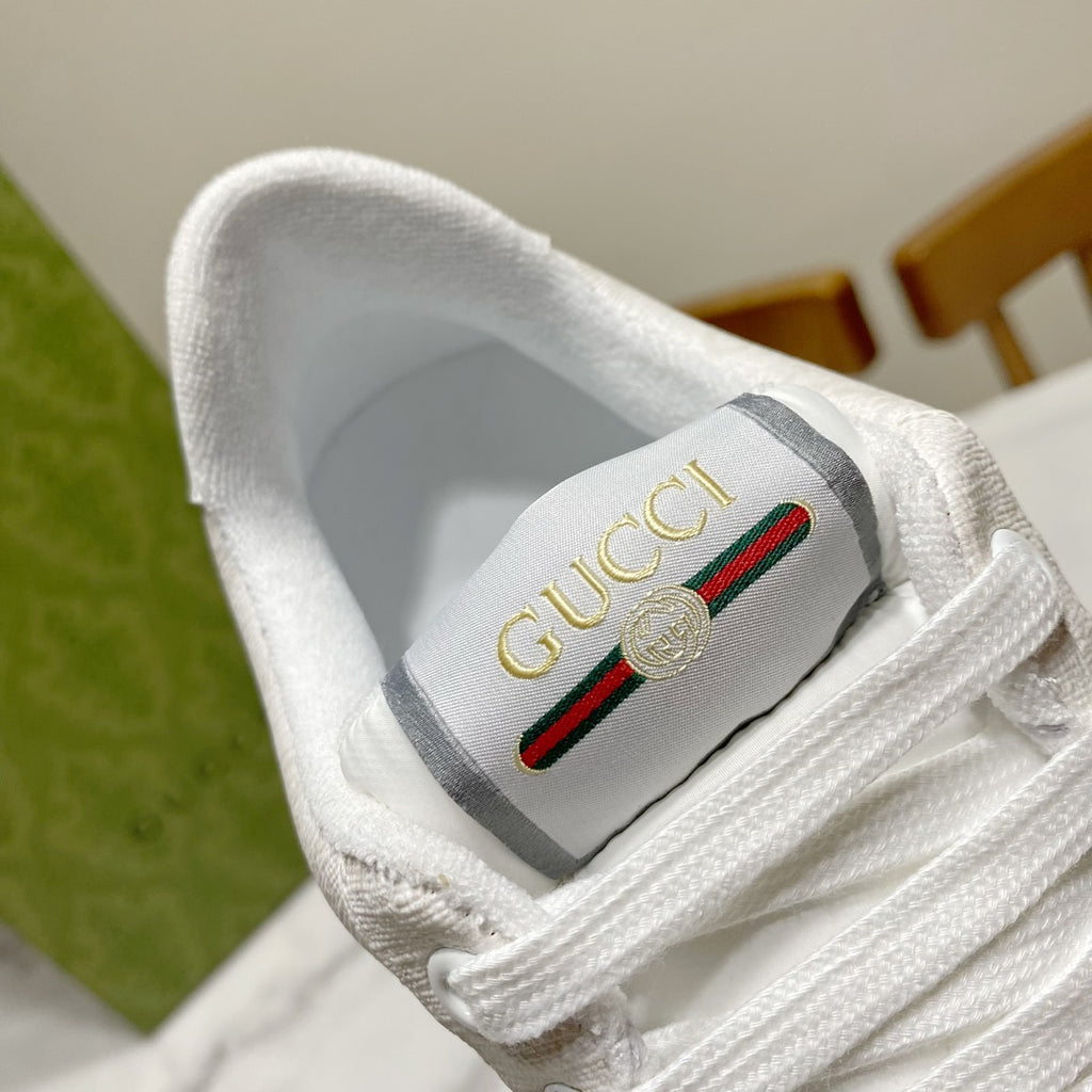 Gucci unisex sneaker tongue patch with gold Gucci logo and red green stripe