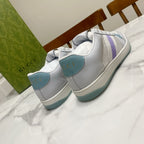 Gucci unisex sneakers, white leather with purple side stripe and teal heel tab.