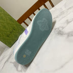 Gucci unisex sneaker outsole, textured teal rubber with embossed bee logo.