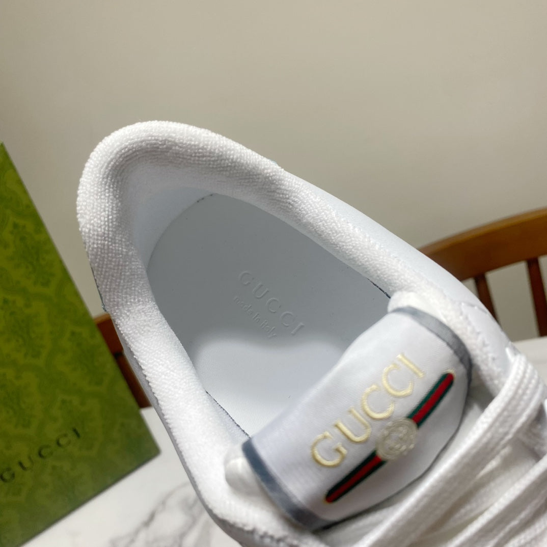 Gucci unisex sneaker lining, white padded collar with Gucci logo patch.
