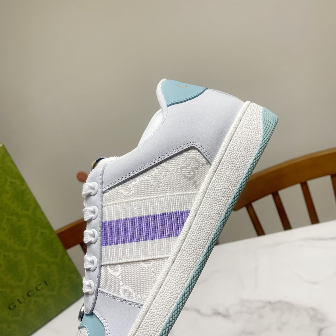 Gucci unisex sneaker side, white leather with embossed details and purple stripe.