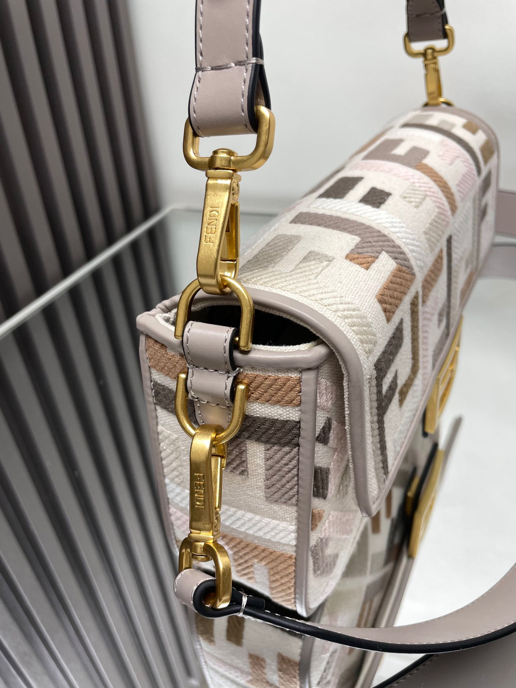 Fendi small bag with F-end pattern, side profile, chain strap, gold hardware