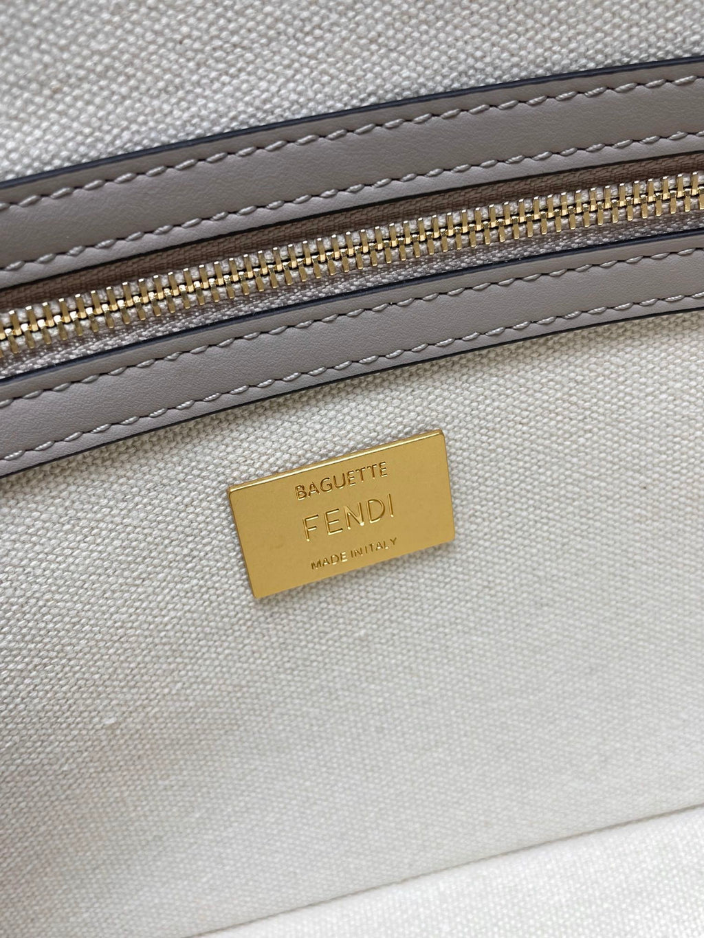Fendi bag interior tag reading “BAGUETTE” and “FENDI” on light lining