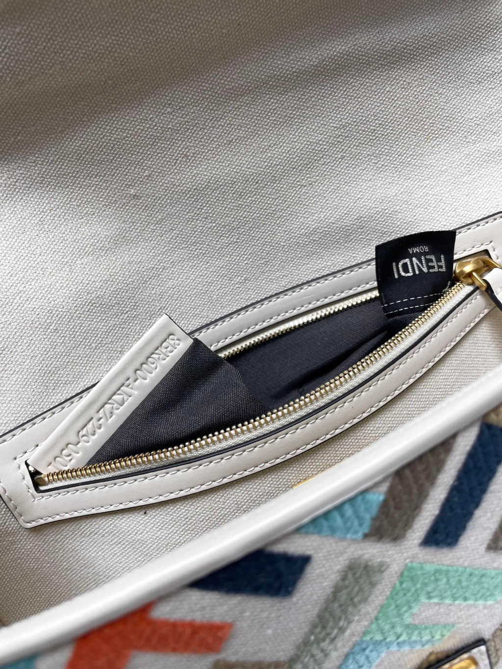 Fendi baguette bag interior zipper pocket with gold zipper and navy fabric lining