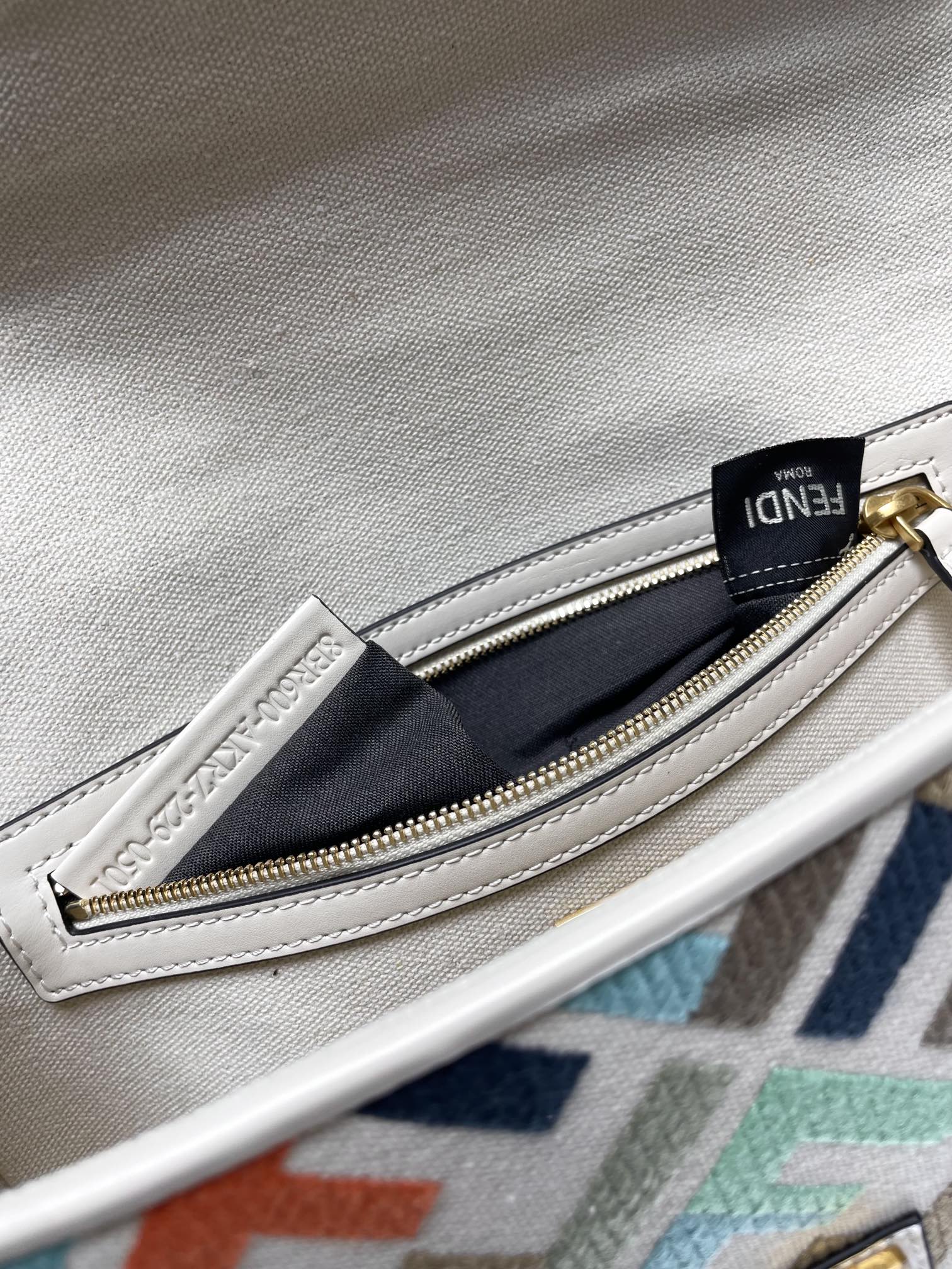 Fendi baguette bag interior zipper pocket with gold zipper and navy fabric lining