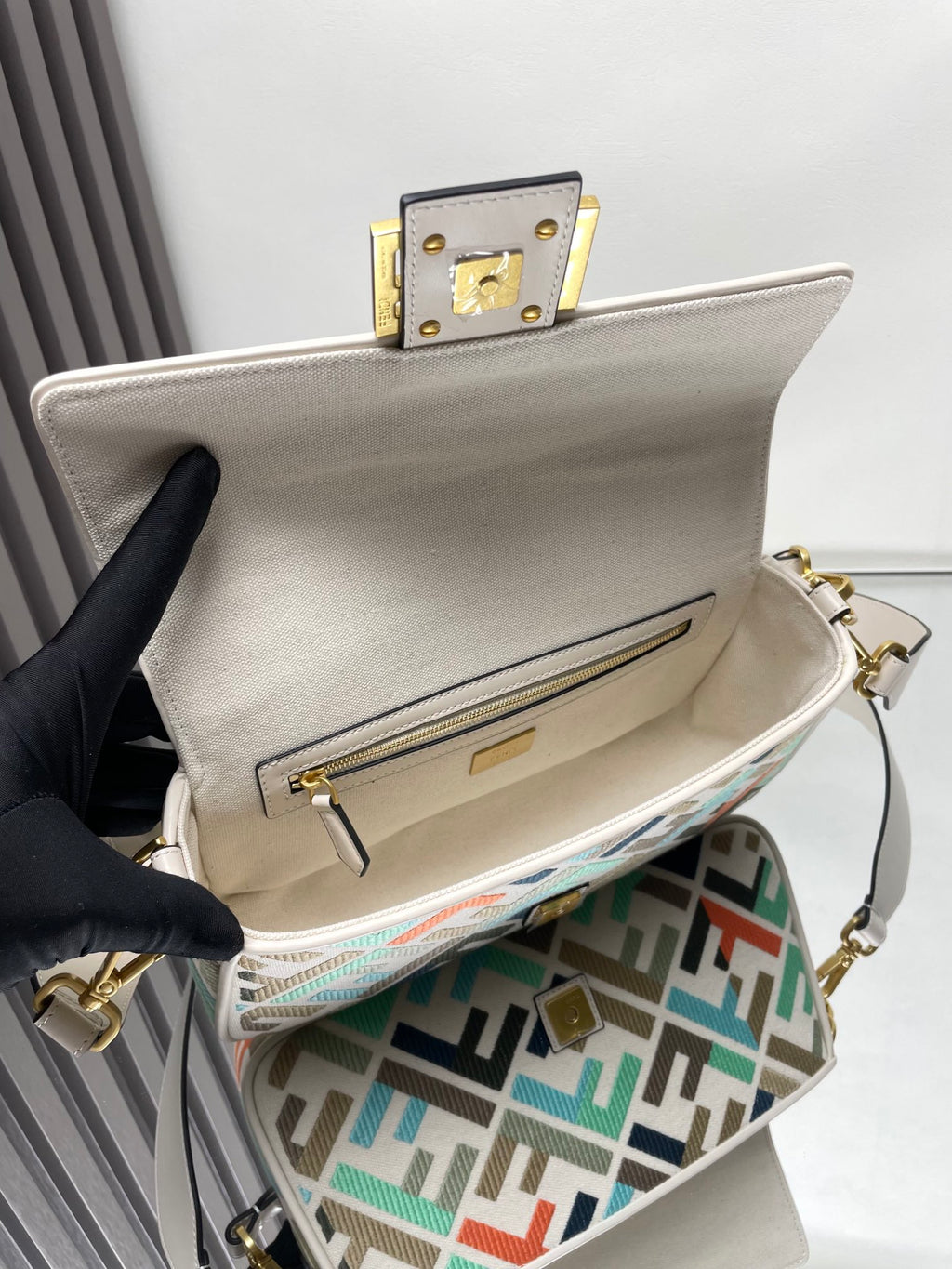 Fendi baguette bag open, beige interior and front pocket with gold zipper on FF lining