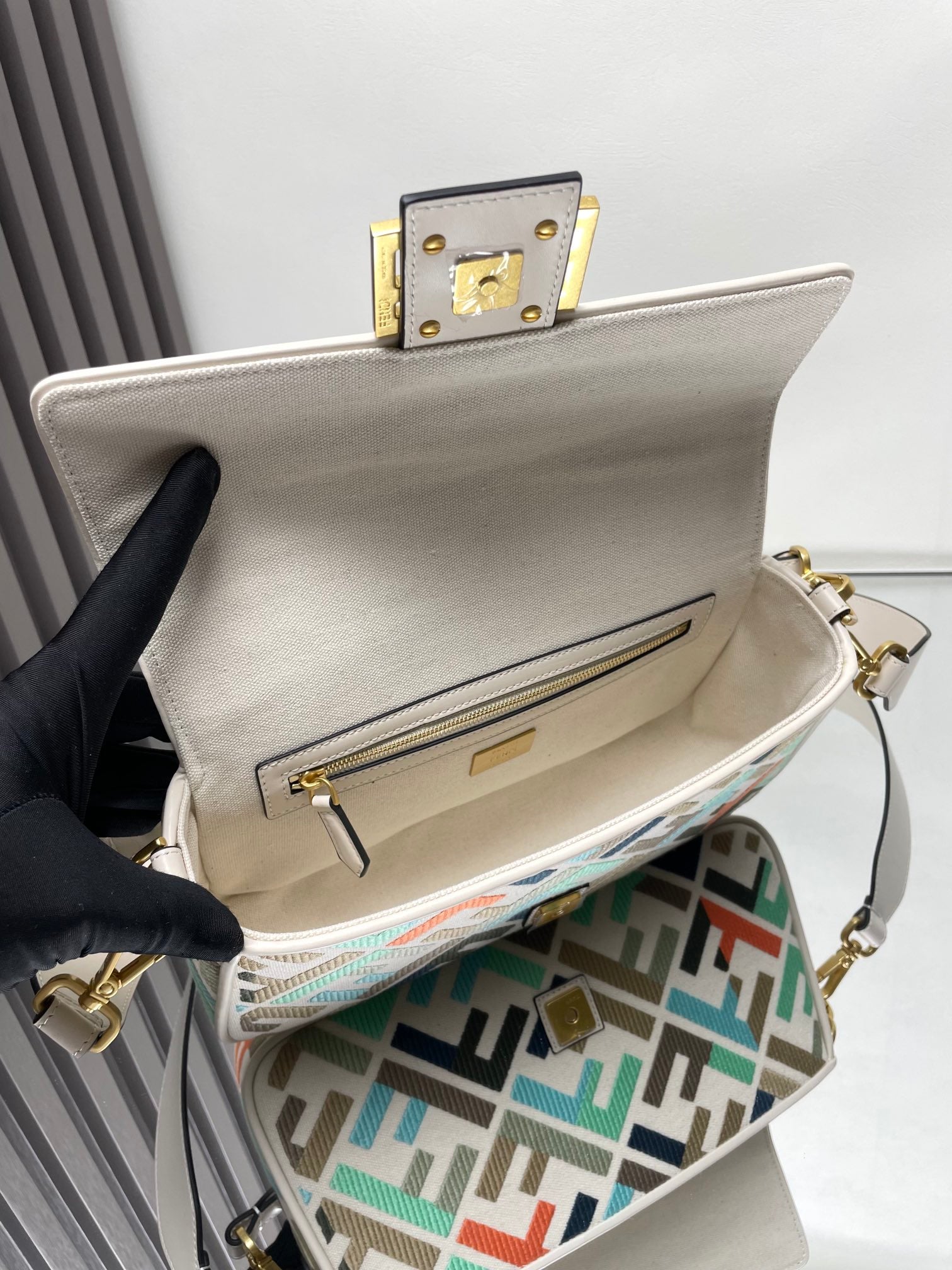 Fendi baguette bag open, beige interior and front pocket with gold zipper on FF lining
