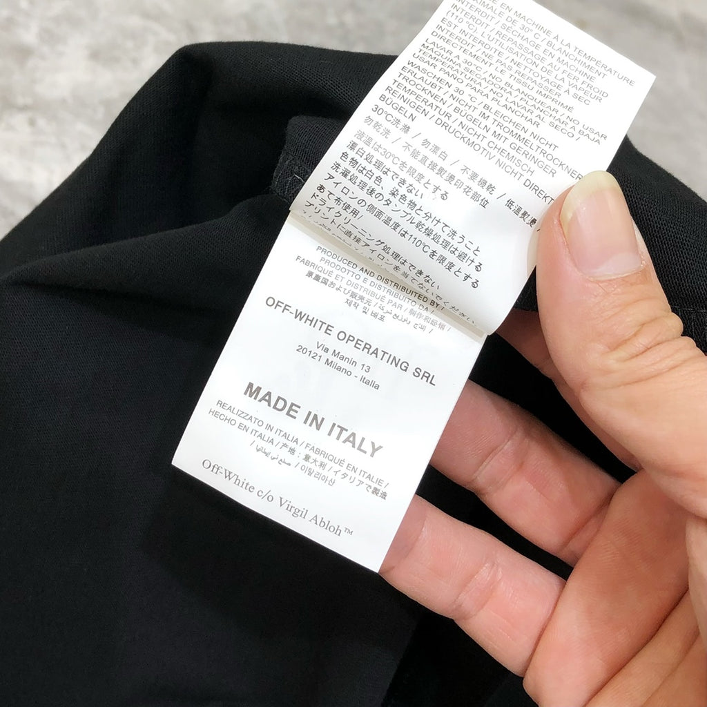 Black T-shirt with care label showing “Made in Italy”