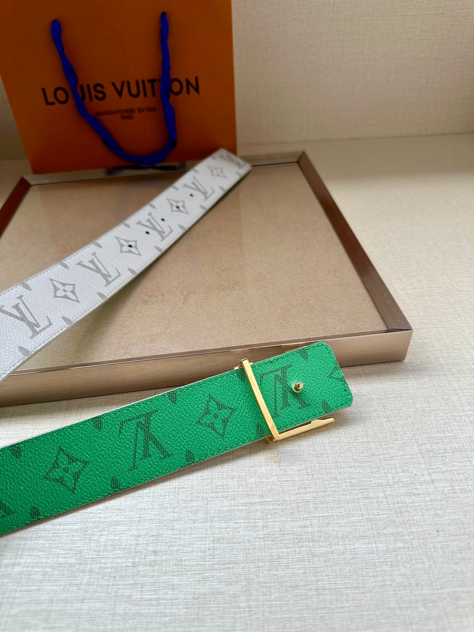 Louis Vuitton monogram belt in green with matching leather keeper, with white side.