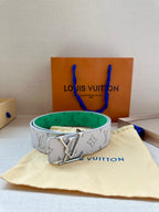 Louis Vuitton monogram belt in white with green lining and silver LV buckle, centered.