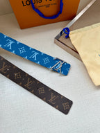 Louis Vuitton monogram belts in blue and brown with silver LV buckles, patterned.