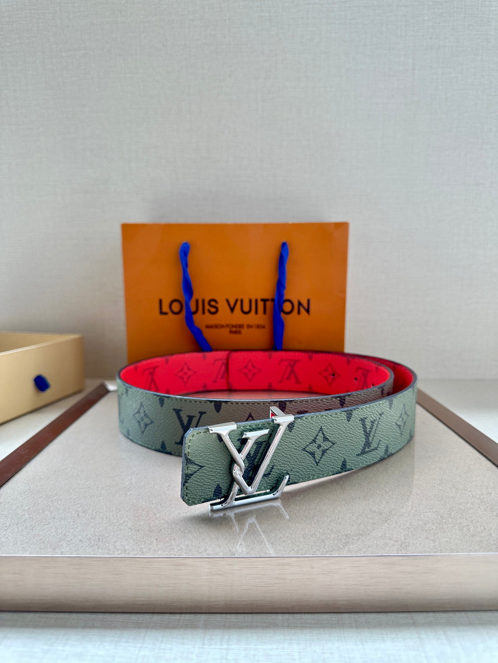 Louis Vuitton belt with mint monogram strap and silver-tone buckle, red underside