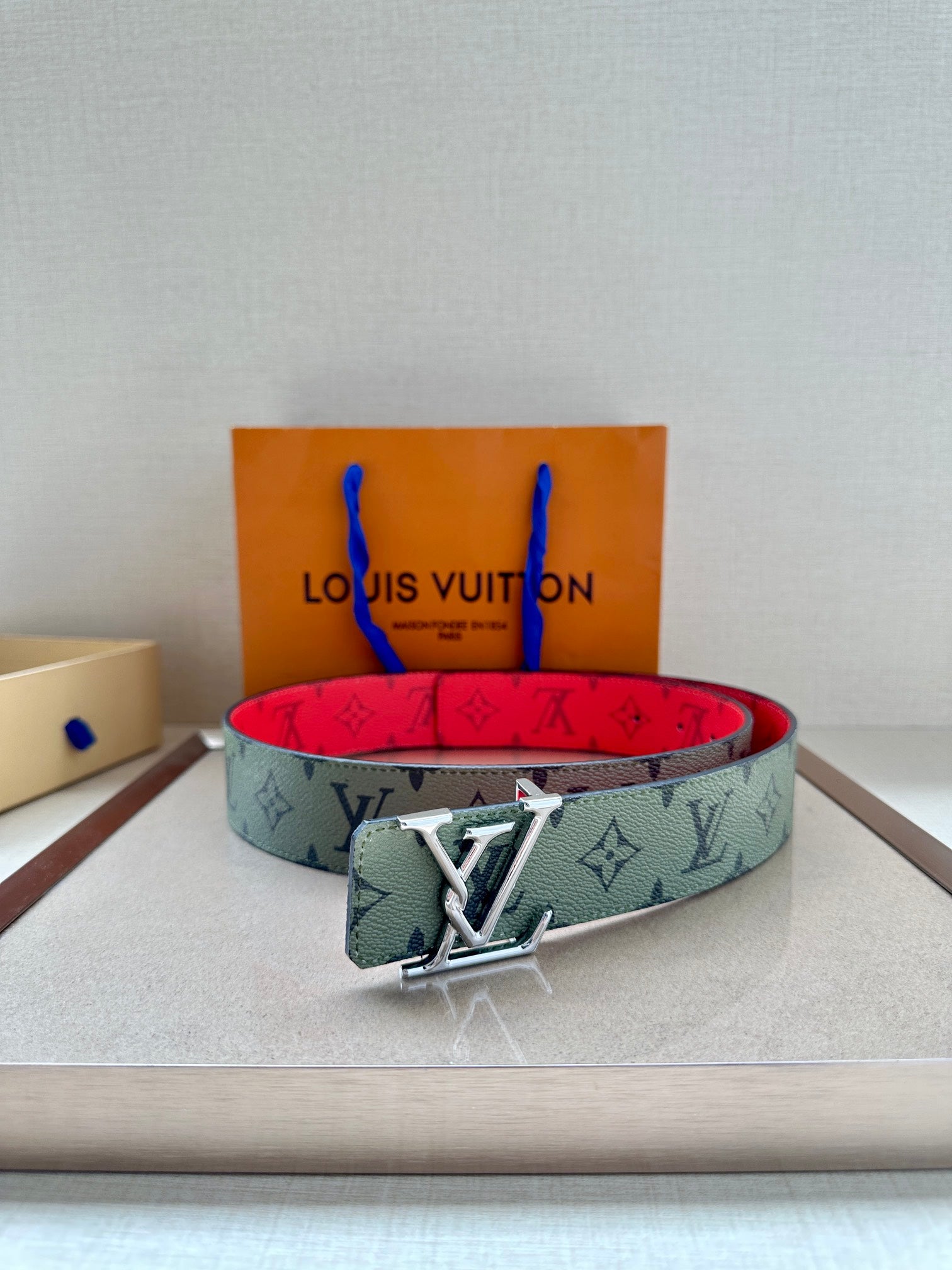 Louis Vuitton belt with mint monogram strap and silver-tone buckle, red underside