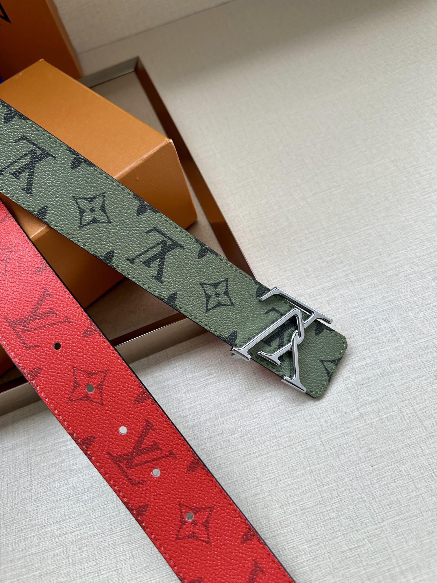 Louis Vuitton belt with textured red strap and silver-tone buckle