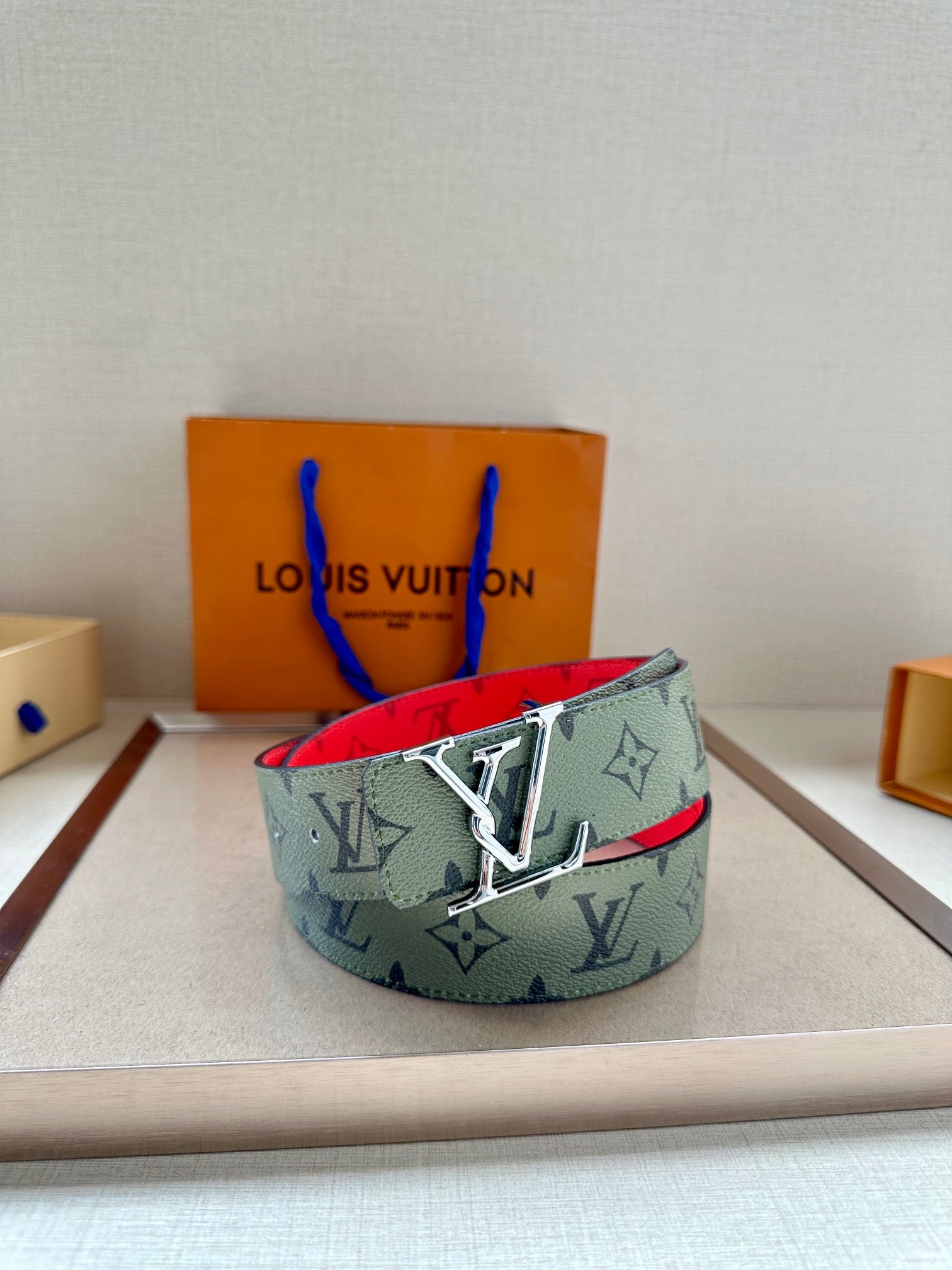 Louis Vuitton belt with mint monogram strap and silver-tone buckle, red underside
