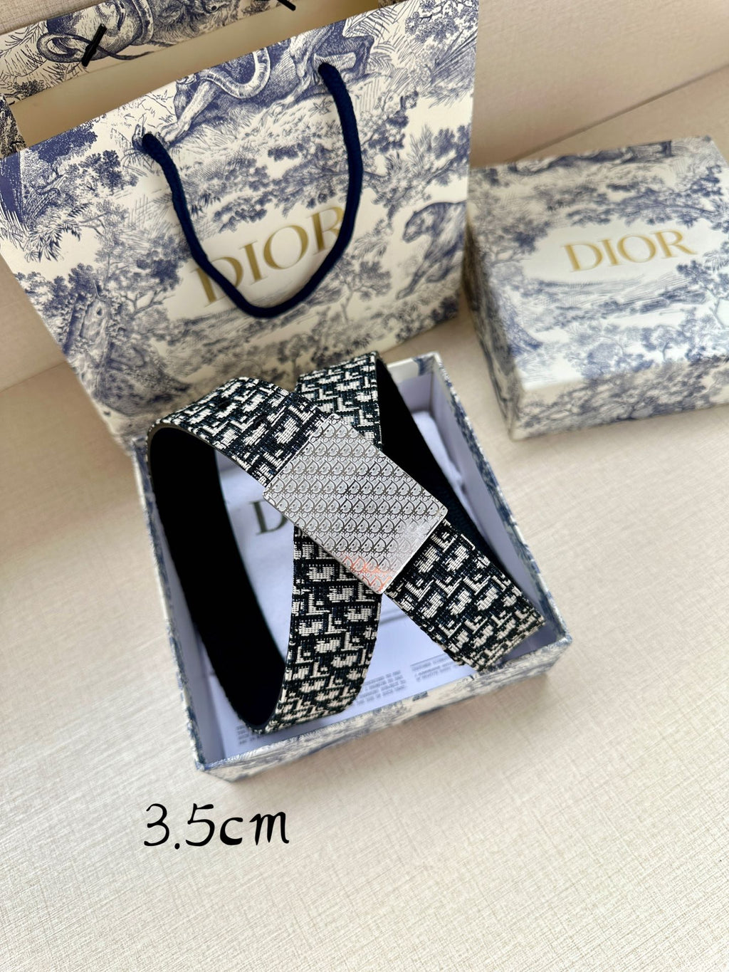 Dior belt and matching box, featuring black and white woven-look logo pattern