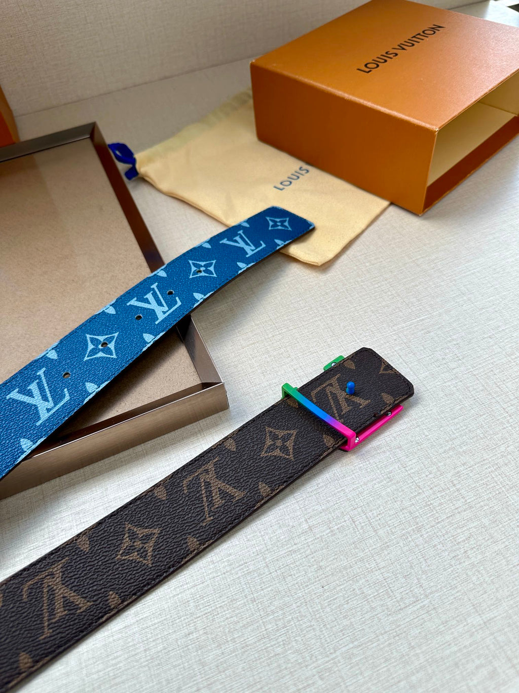 Louis Vuitton blue and brown monogram belts with metal buckles