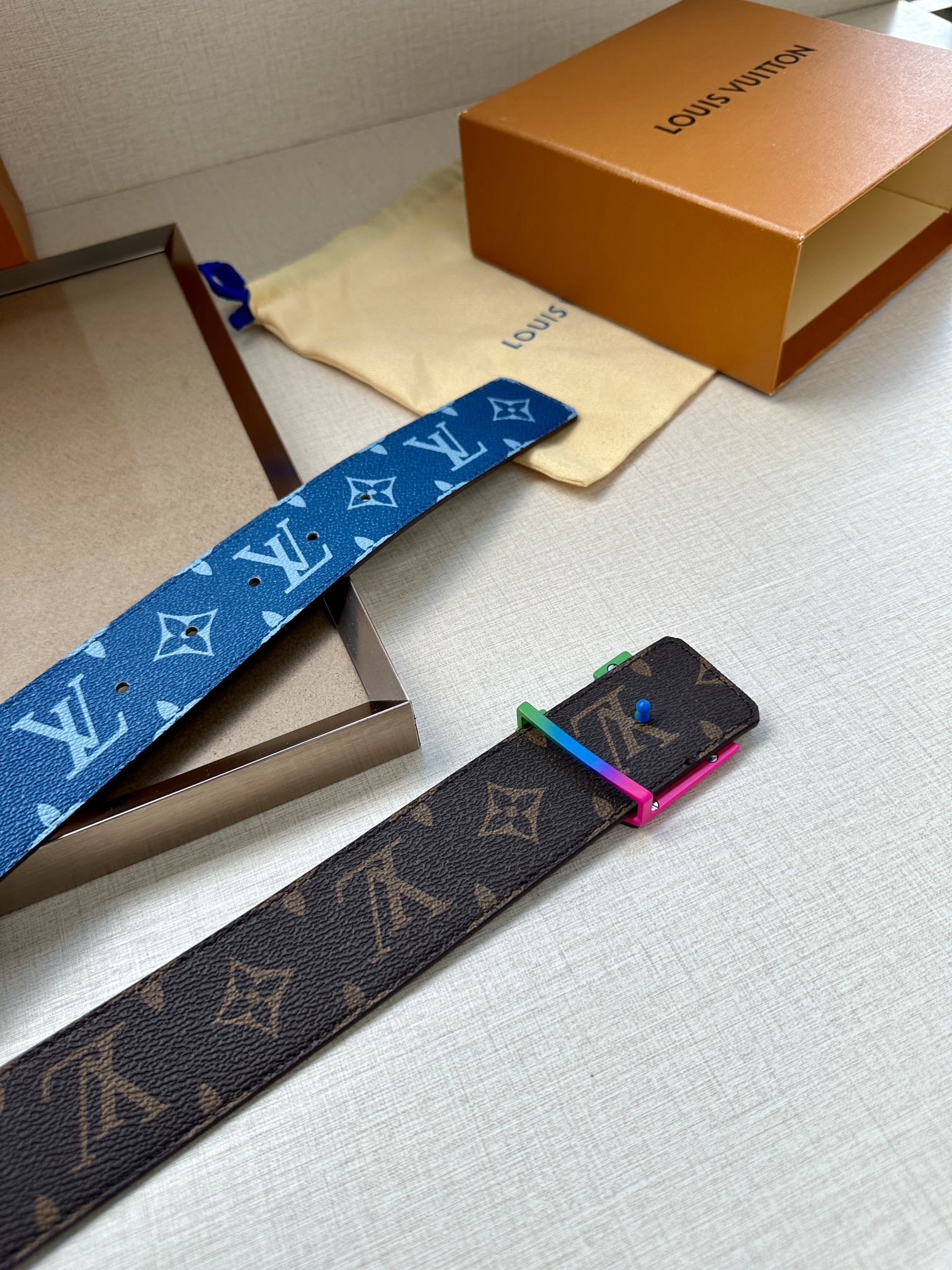 Louis Vuitton blue and brown monogram belts with metal buckles