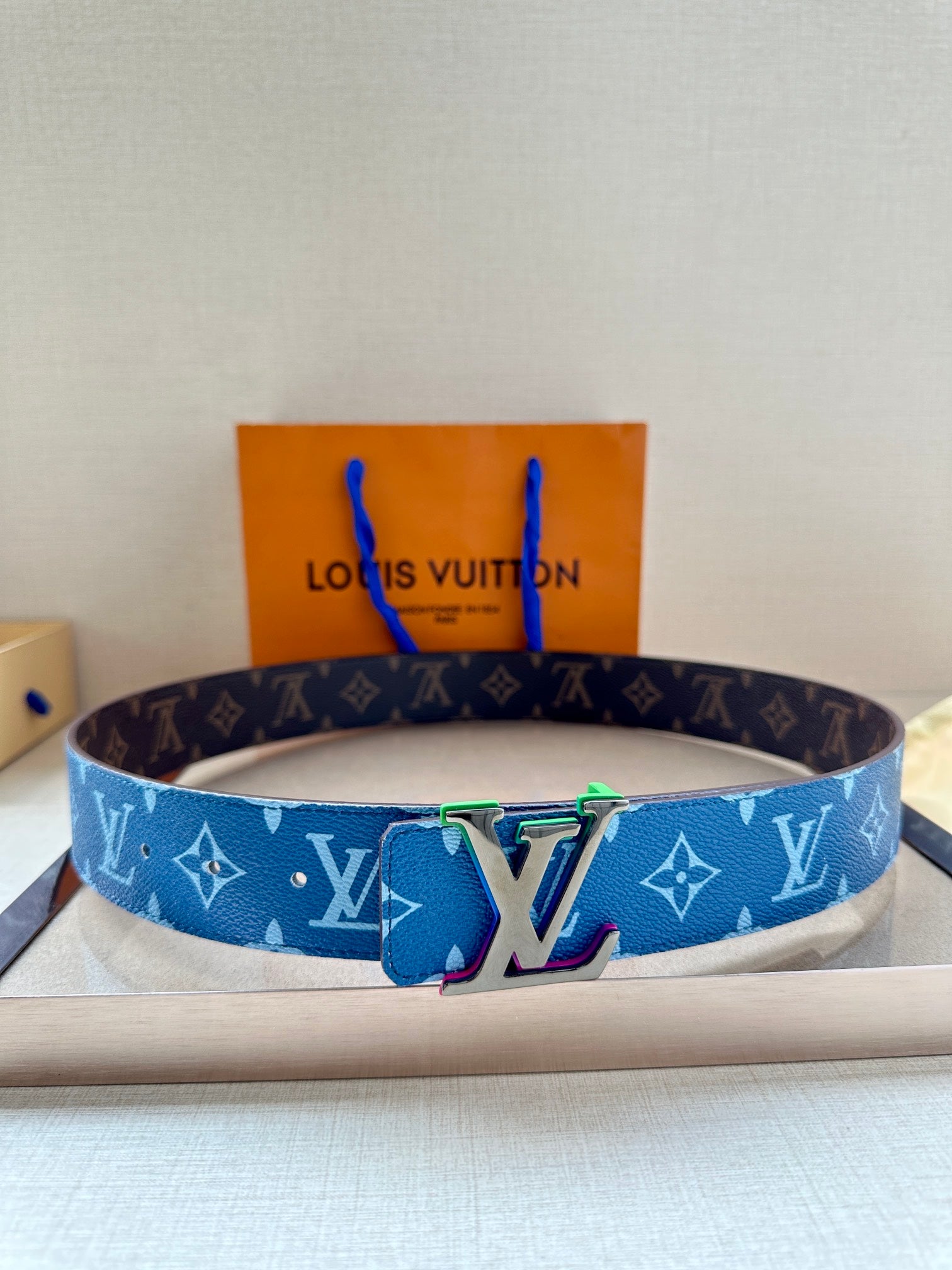 Louis Vuitton blue monogram belt with silver buckle and multicolor emblem detail