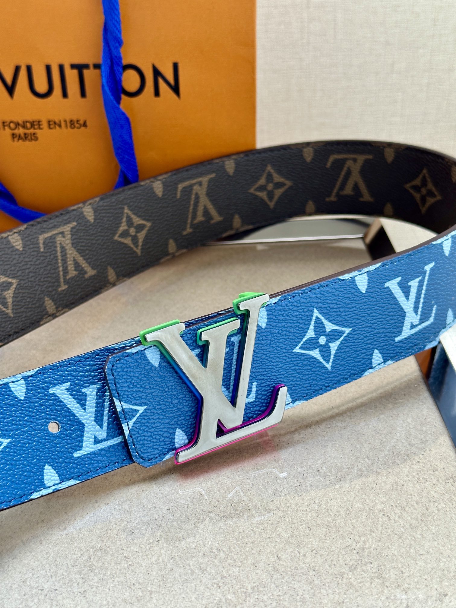 Louis Vuitton blue monogram belt with large silver LV buckle and green accents