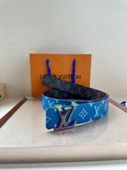 Louis Vuitton blue monogram belt with silver buckle, displayed on a surface