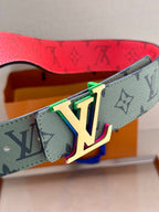 Louis Vuitton belt buckle close-up with multicolor LV emblem on light green strap