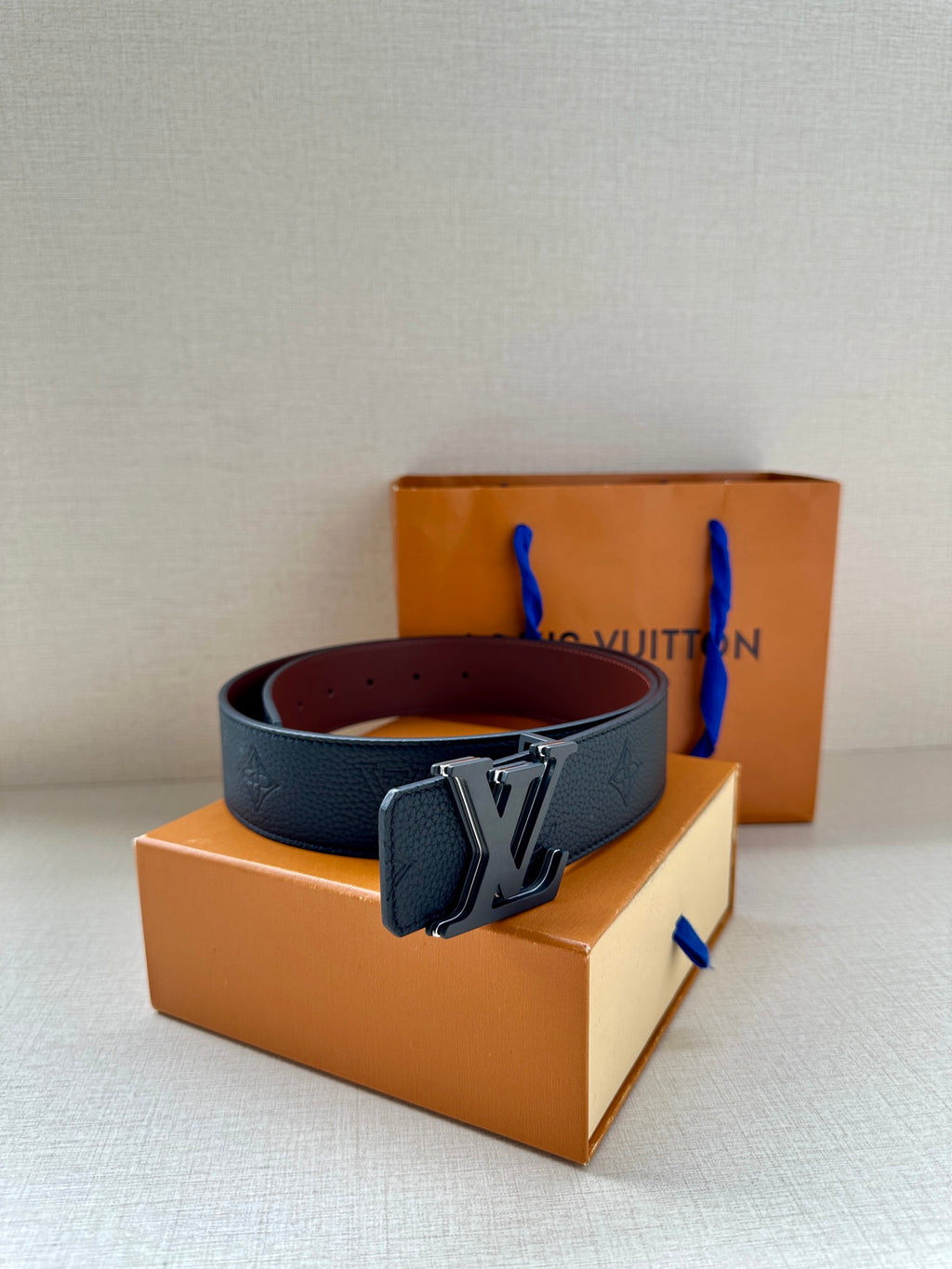 Louis Vuitton belt with dark blue leather strap and silver-tone LV buckle