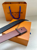 Louis Vuitton belt with dark blue strap, silver-tone buckle, and pink leather tab