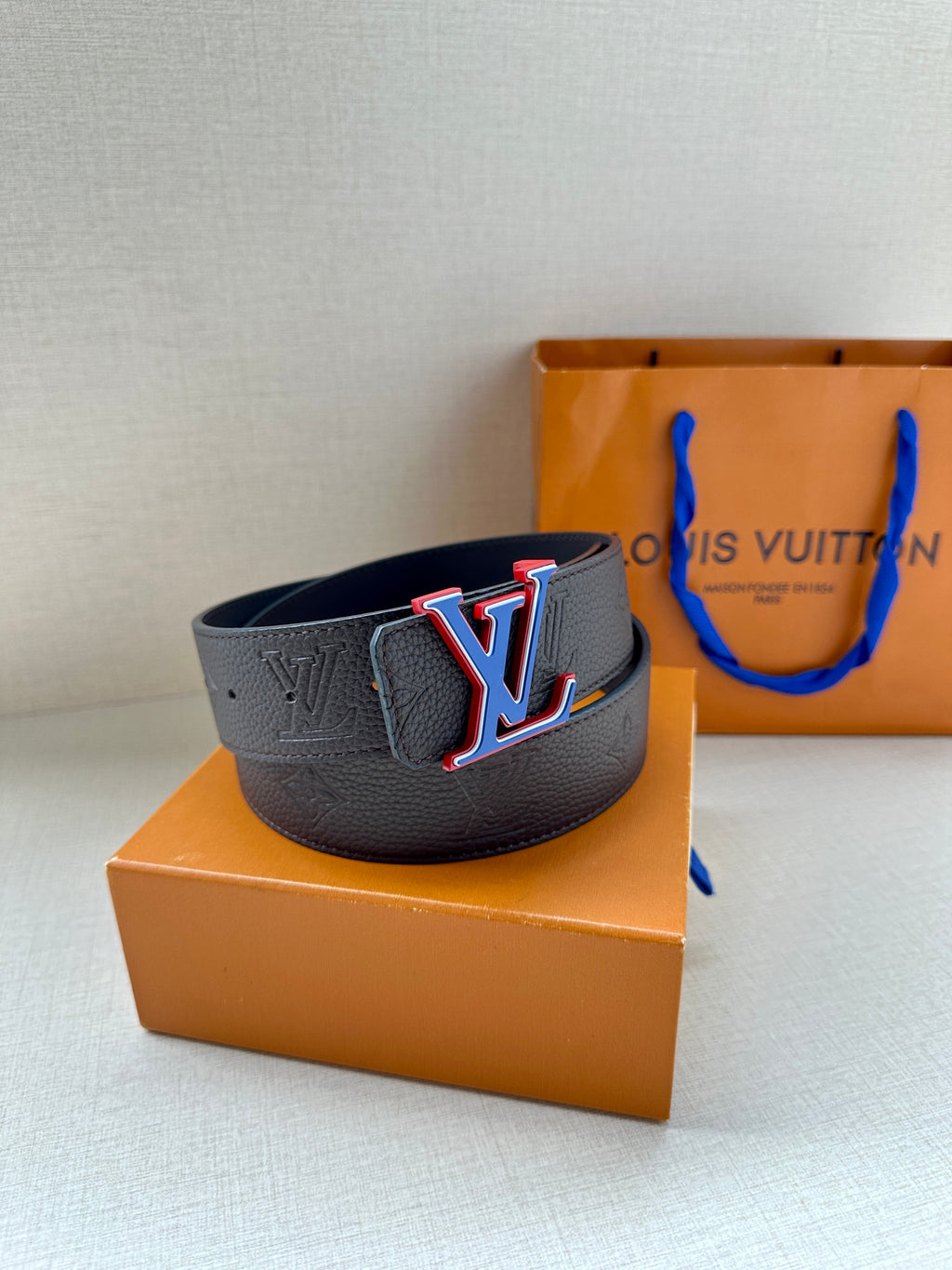 Louis Vuitton textured leather belt with LV logo buckle, dark blue