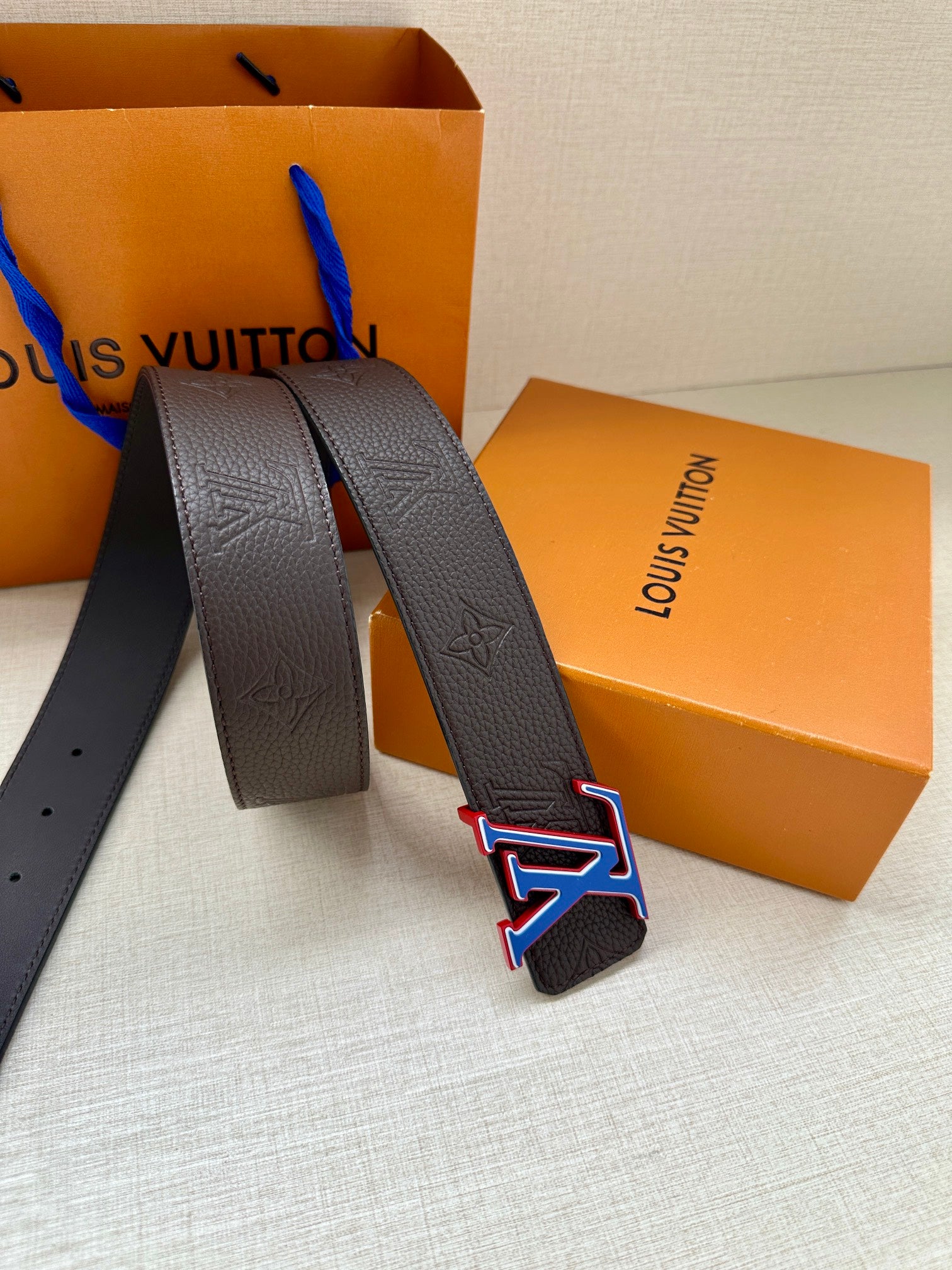 Louis Vuitton leather belt strap ends with LV logo buckle, textured dark blue