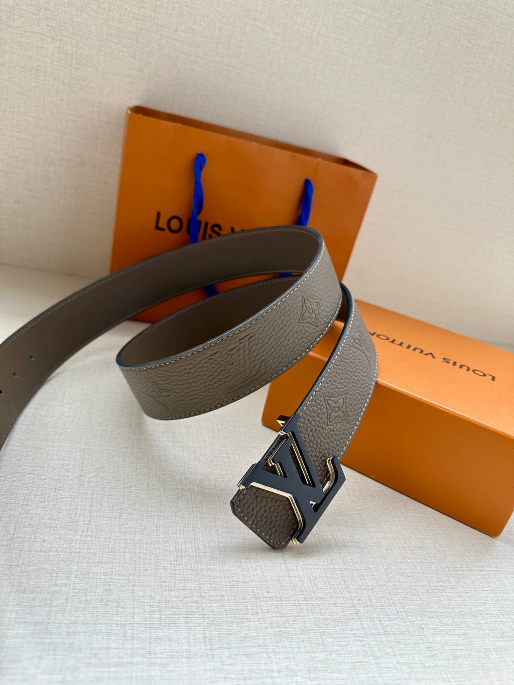 Gray leather belt with large LV buckle and adjustable holes