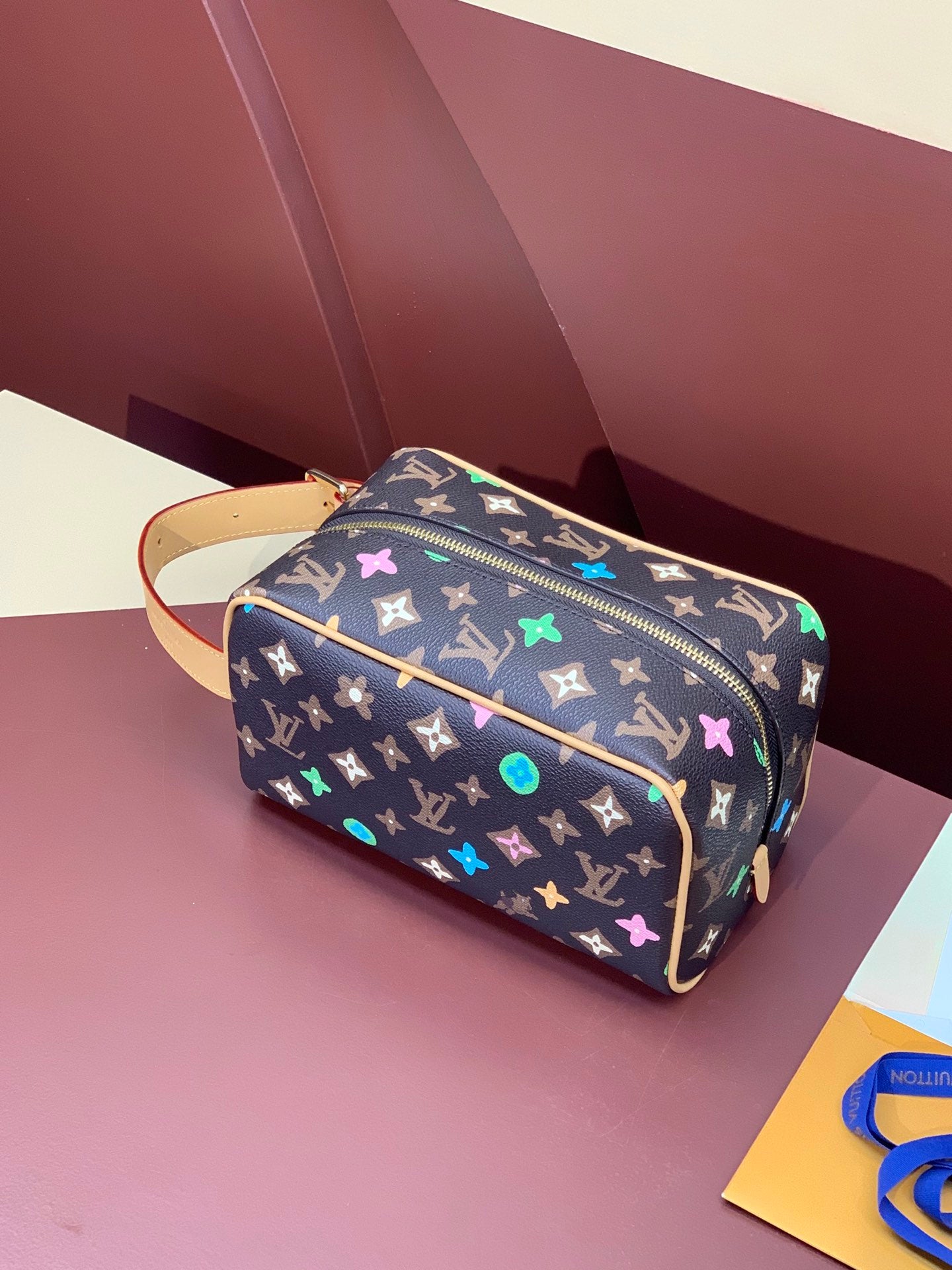 Louis Vuitton monogram vanity bag with zipper and multicolor star pattern, tan strap