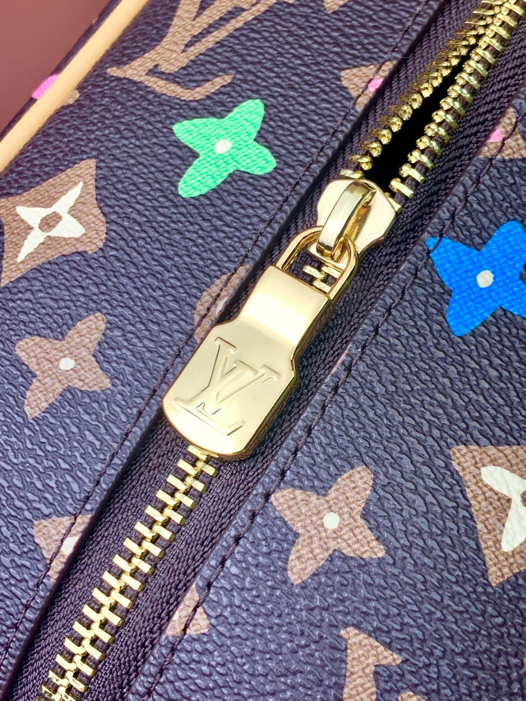 Navy monogram bag zipper and gold pull with multicolor star motifs