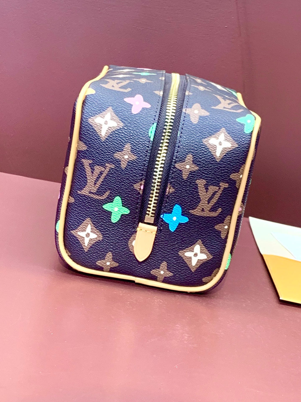 Navy monogram zip pouch bag with multicolor star and butterfly prints, gold trim