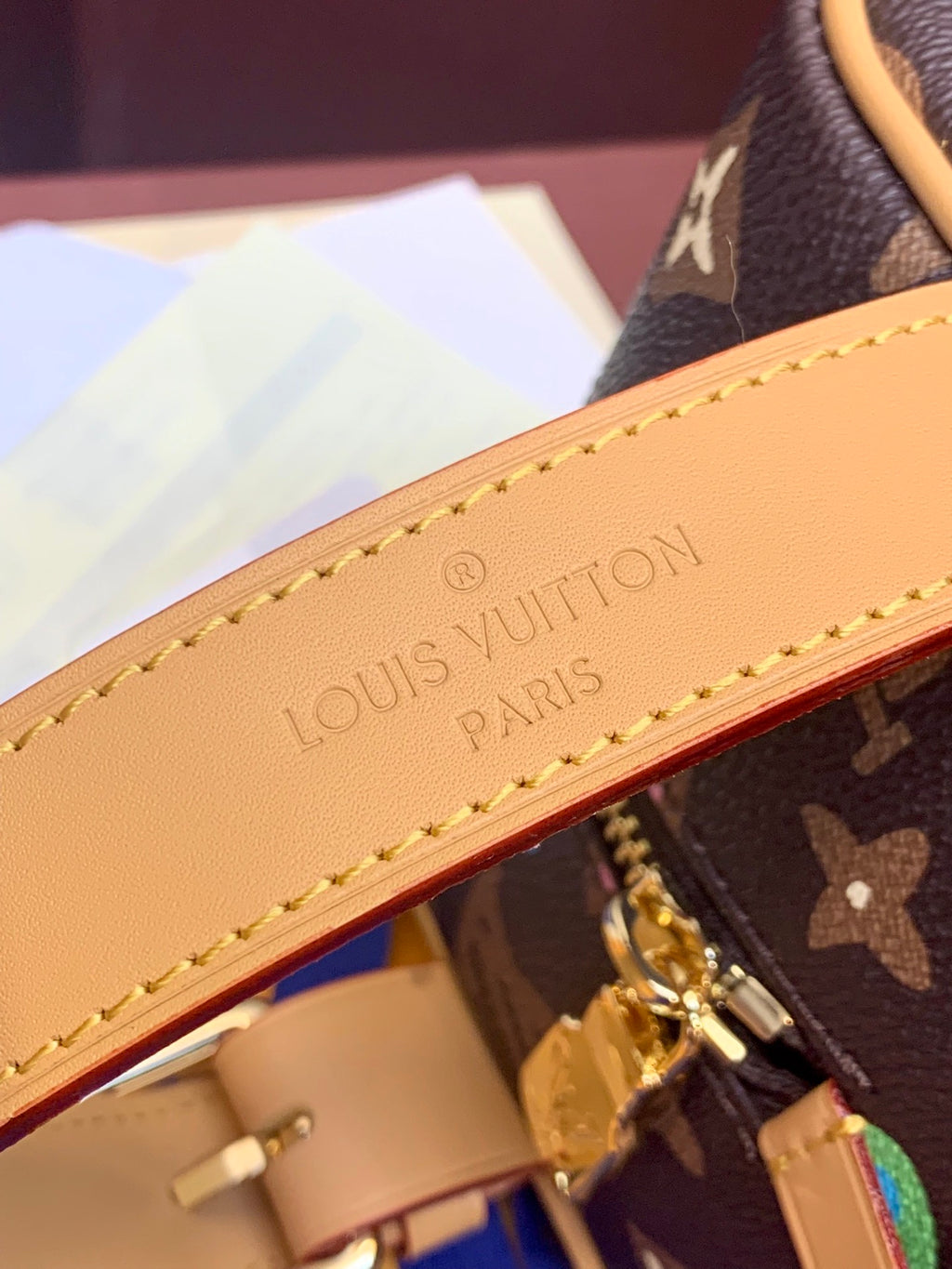 Tan leather interior edge with embossed lettering and stitched trim