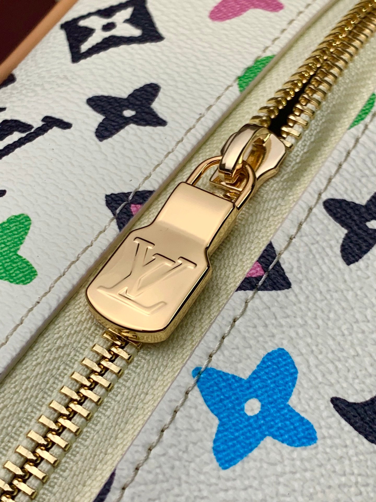 Louis Vuitton gold zipper pull and clasp on multicolor monogram canvas, tan piping