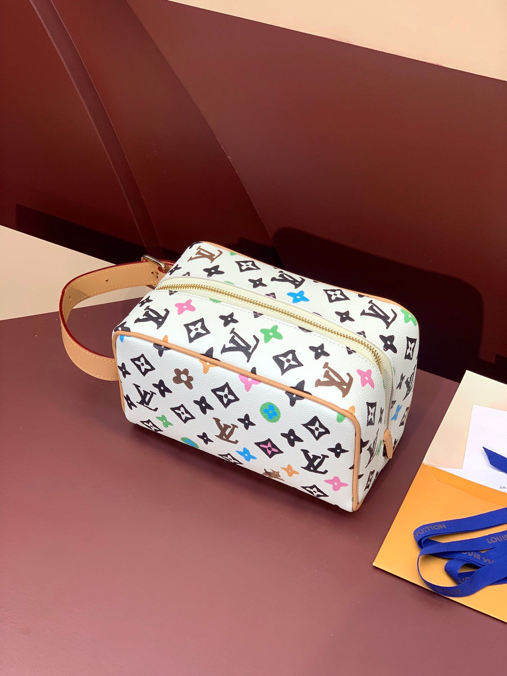 Louis Vuitton crossbody bag, multicolor monogram canvas, tan leather strap, gold zipper hardware