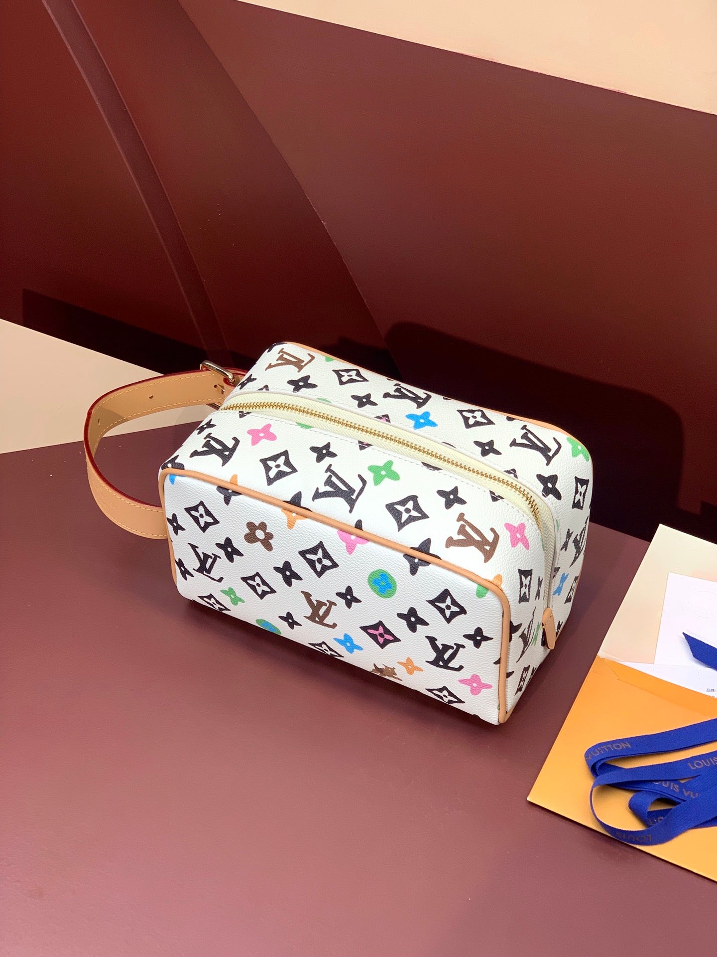 Louis Vuitton crossbody bag, multicolor monogram canvas, tan leather strap, gold zipper hardware