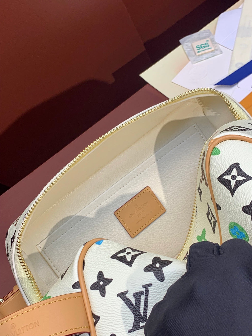 Louis Vuitton bag interior with beige lining and multicolor monogram pattern, zip top