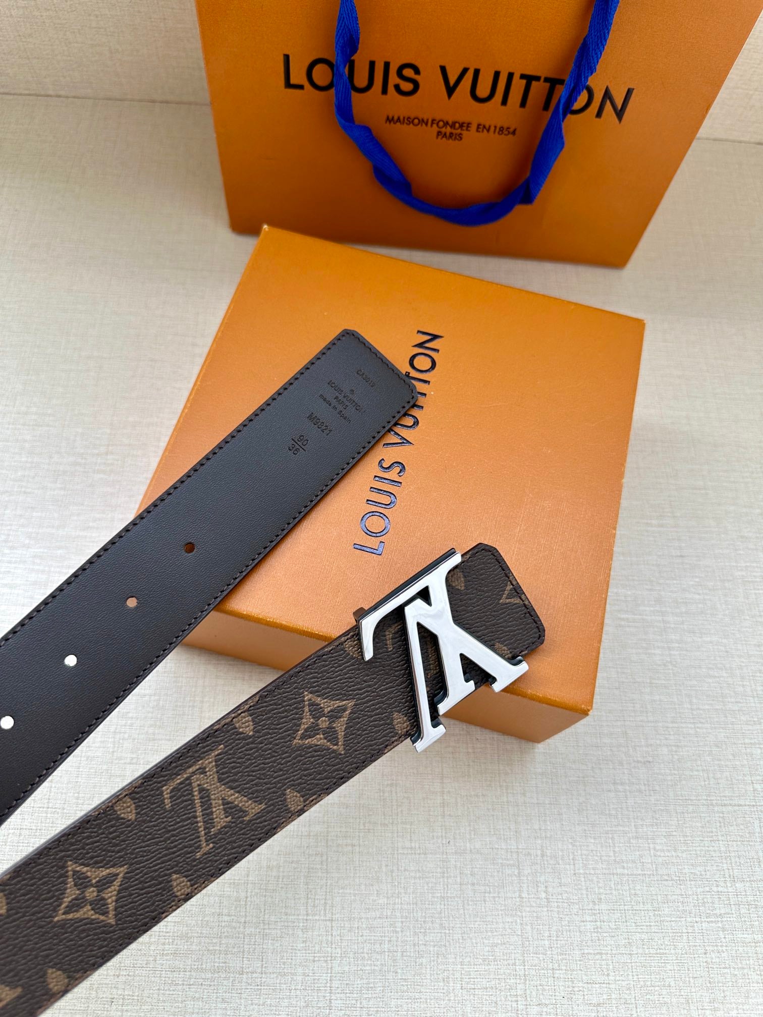 Louis Vuitton monogram belt with LV buckle and perforated adjustment holes