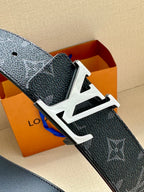 Dark monogram belt with wide silver-tone buckle and textured leather strap