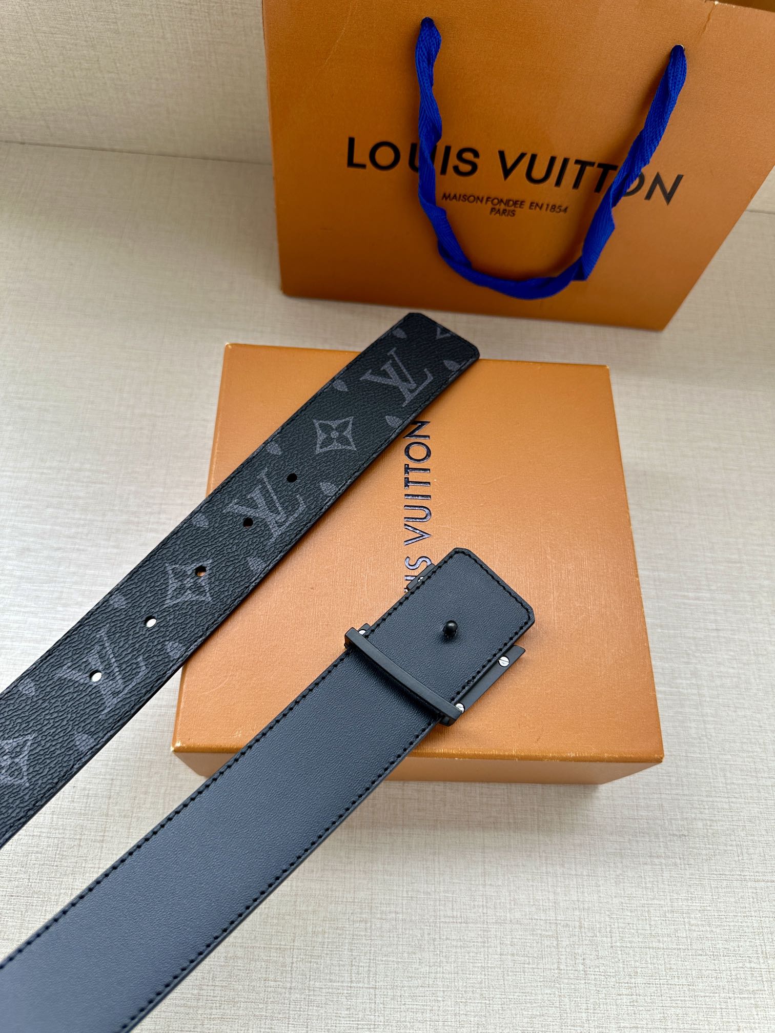 Navy monogram belt strap with matching leather keeper and hole rows
